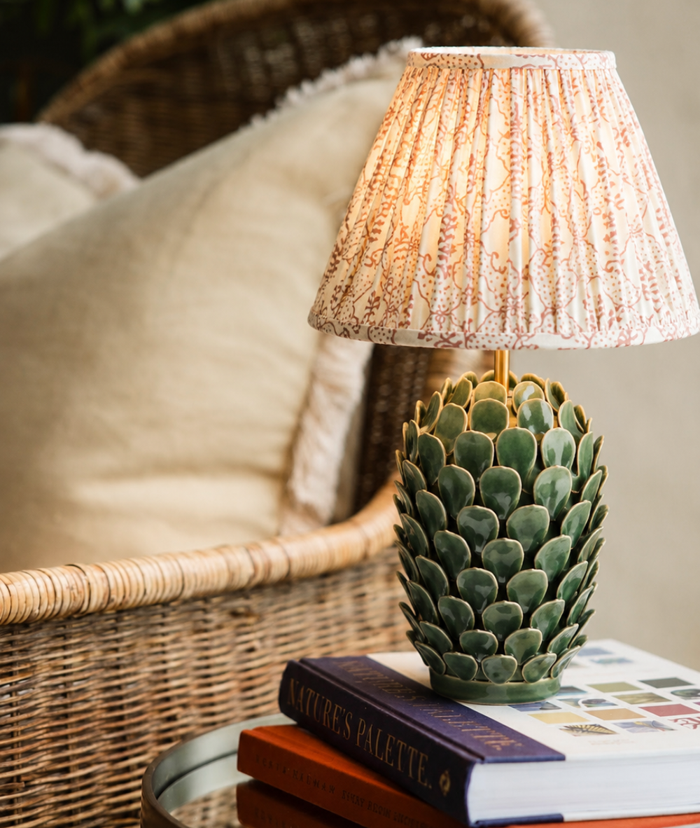Paloma Lamp in pine green ceramic styled with a gathered shade in a room